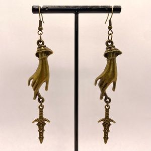 Victorian hand with ornate dagger earrings  Bronze tone